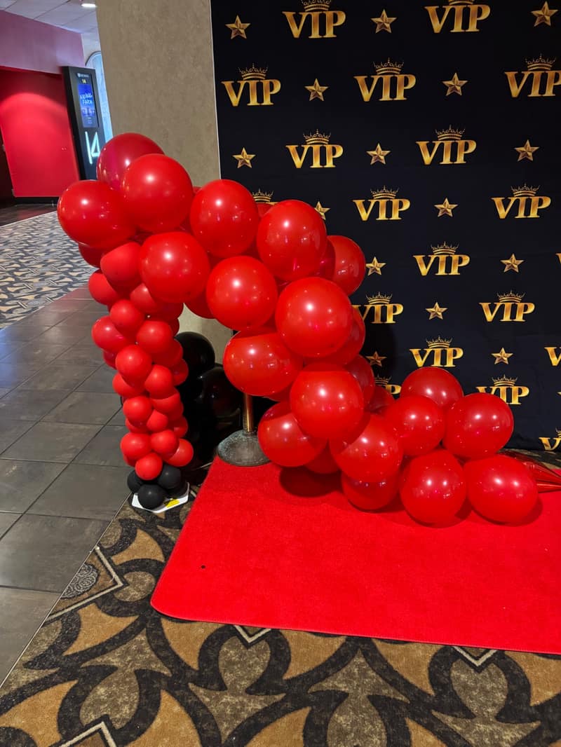 Red and black VIP balloon backdrop by Full of Hot Air near Olathe, KS