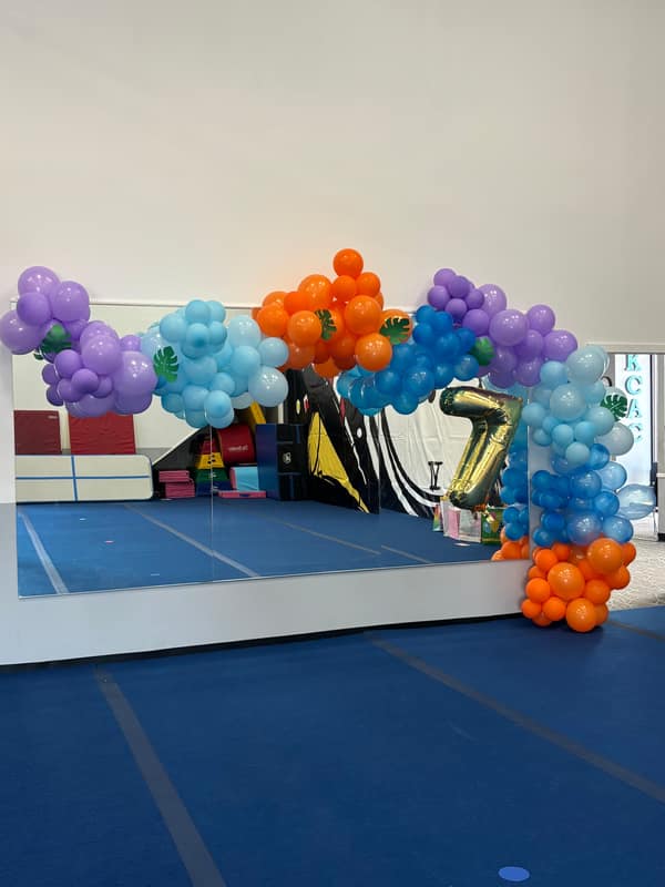 Purple, orange and blue tropical balloon arch built for a Kansas City birthday party
